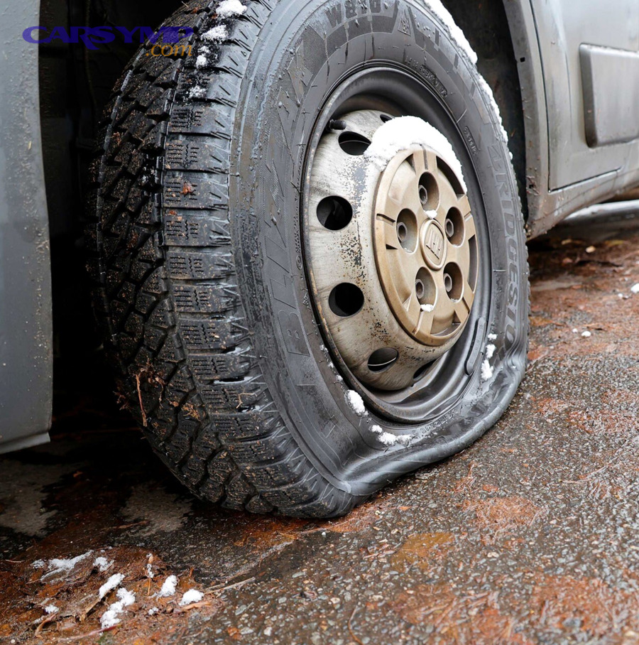 Deflated car tire close-up