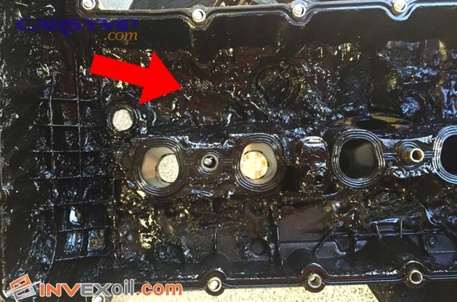 Engine oil filler cap showing sludge deposits