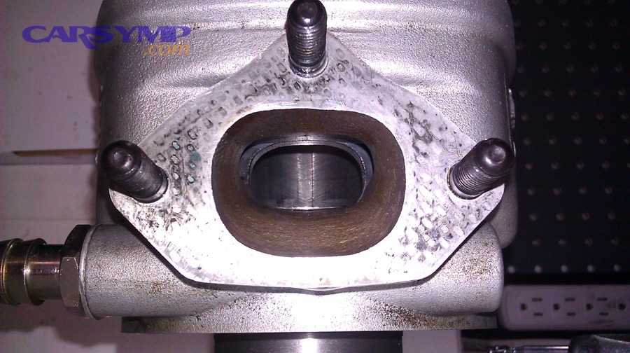 Exhaust port flange face where leaks can occur if sealing surfaces or studs are compromised