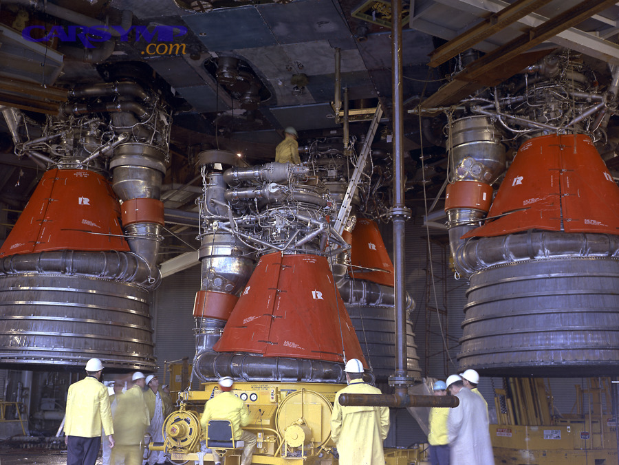 Large engines being installed, illustrating labor intensity and installation complexity that also apply to automotive engine replacement