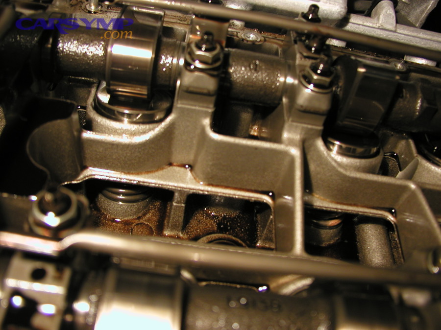 Camshaft lobe contacting a valve lifter; valvetrain contact points can create tapping sounds when clearance changes
