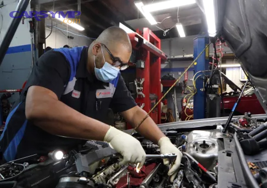 Technician performing a diagnostic scan on a vehicle
