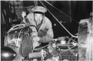 Mechanic at work on automobile in garage NARA 285817 1