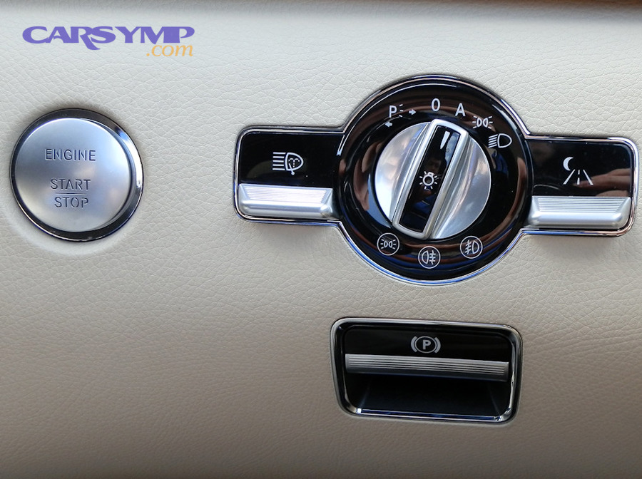 Electric parking brake control button in a car interior