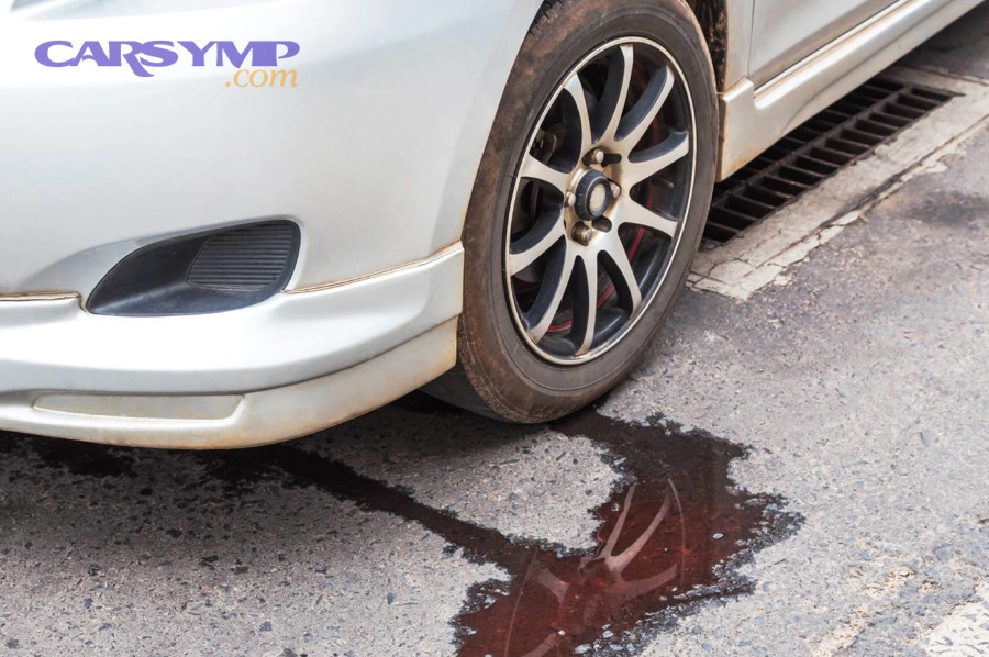 Pouring motor oil into engine with funnel to top up oil level