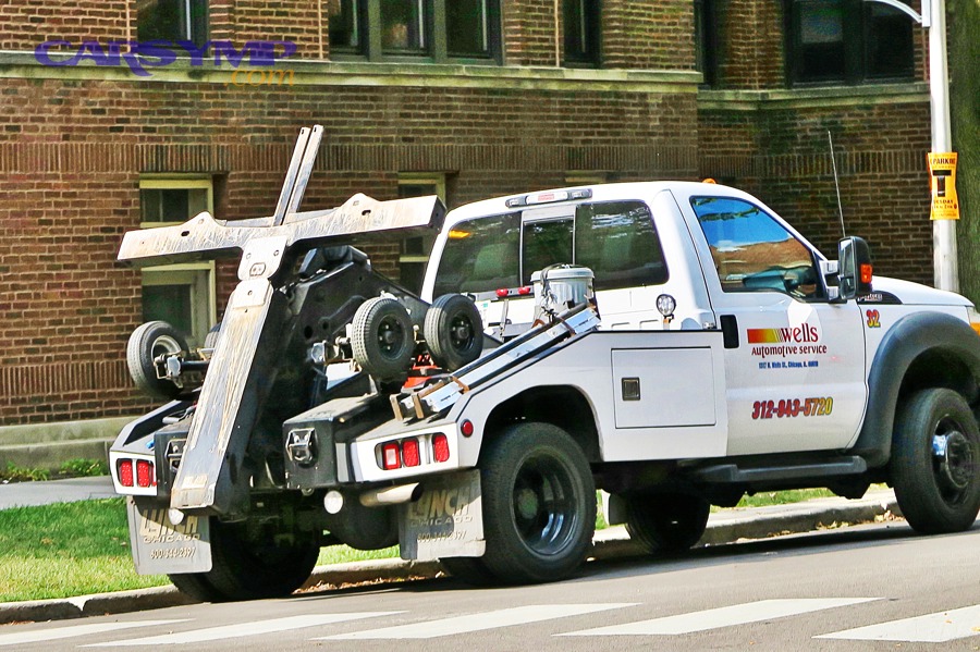 Modern tow trucks lined up in a lot