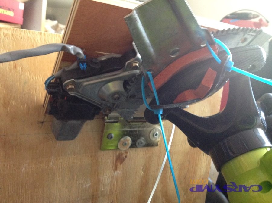 Photo of a motor mounted in a frame showing mounting points and fasteners