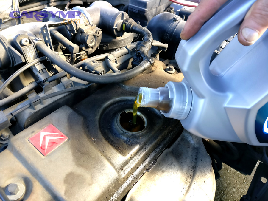 Pouring engine oil into an engine during maintenance