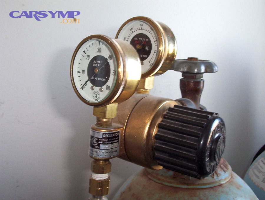Regulator and pressure gauge assembly showing multiple threaded and sealed joints