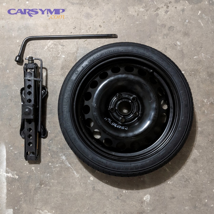 Typical spare tire changing kit with jack and lug wrench