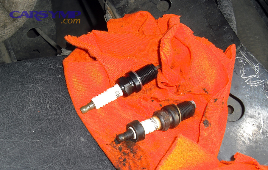 Old vs new spark plugs; deposits can hint at oil burning