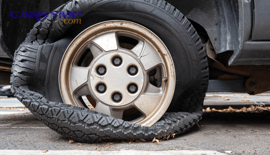 Driver inspecting tire sidewall for damage