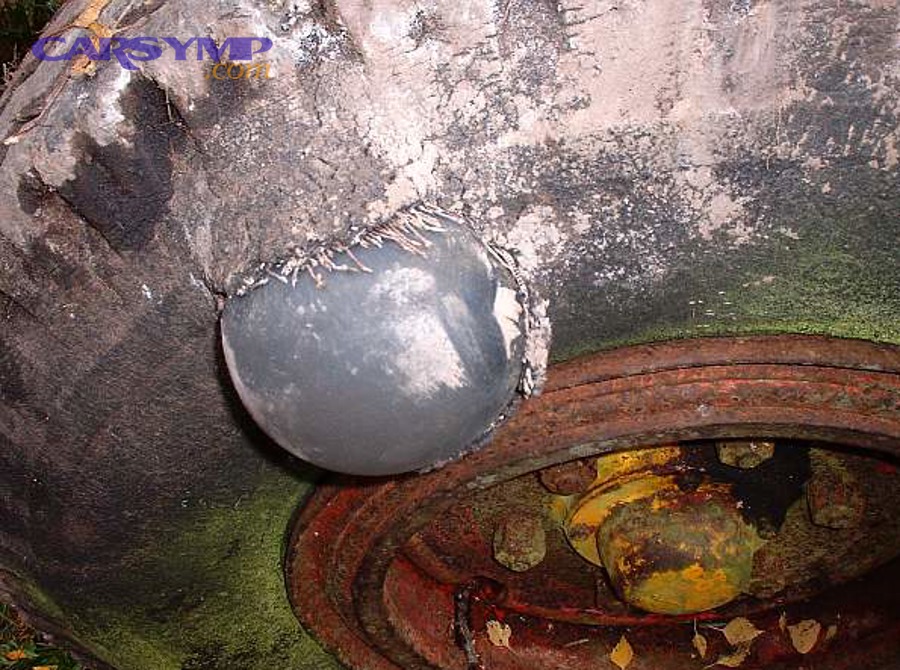 Tire sidewall bulge (hernia) indicating structural damage and non-repairable condition
