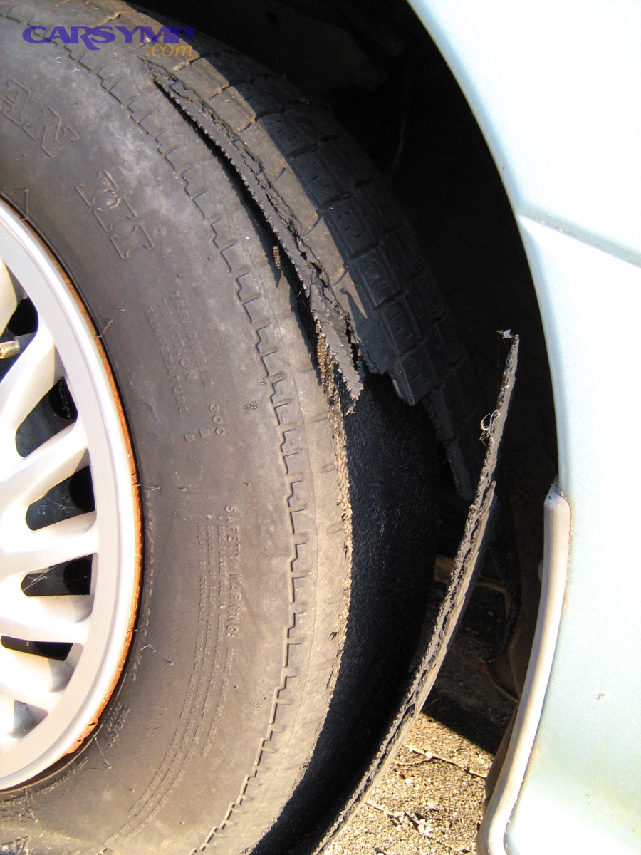 Tire tread separation showing severe structural damage that is not repairable