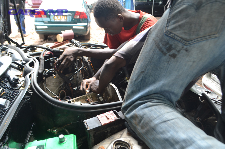 Two mechanic working on a car engine 1