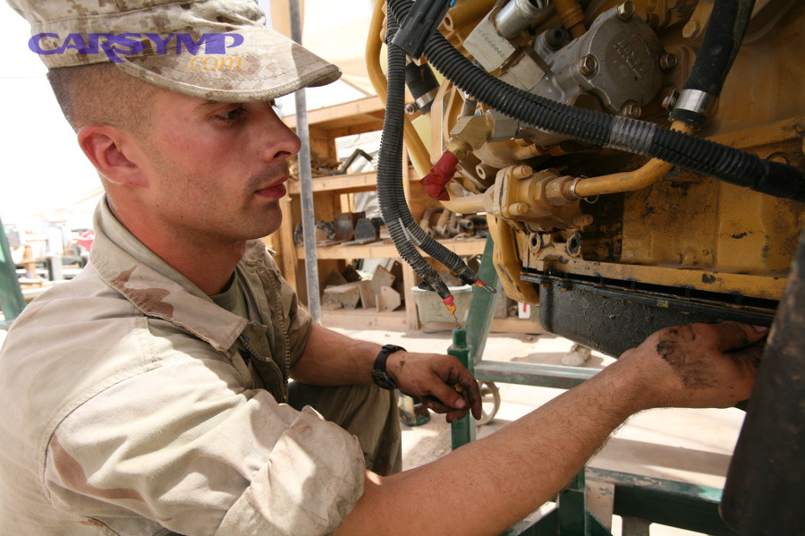 Mechanic performing repairs related to an oil pan gasket on an engine