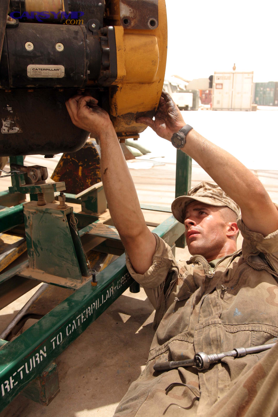 Mechanic working on an engine oil pan area during maintenance