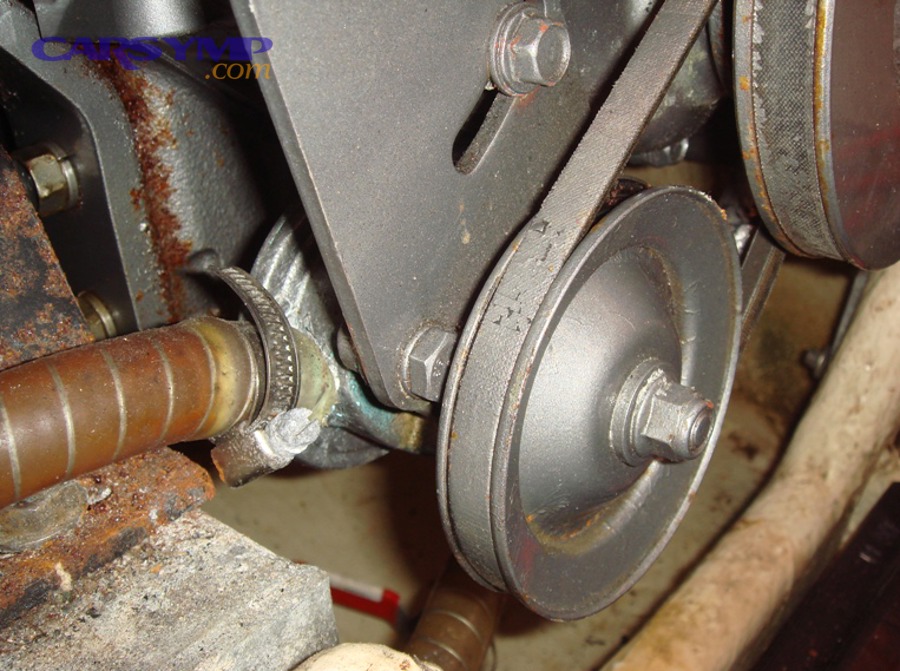 Automotive water pump near drive belt and pulley