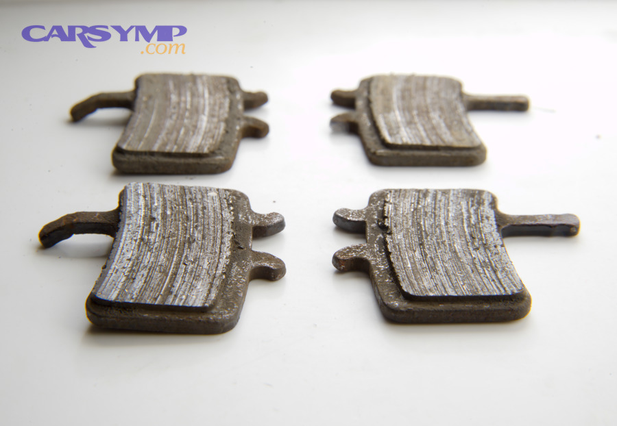 Worn metallic disc brake pads that can lead to grinding noise when braking