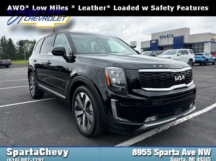 mechanic inspecting vehicle suspension components and brake lines from underneath