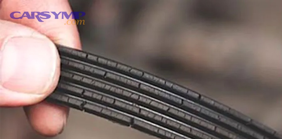 mechanic inspecting serpentine belt for wear and damage under hood