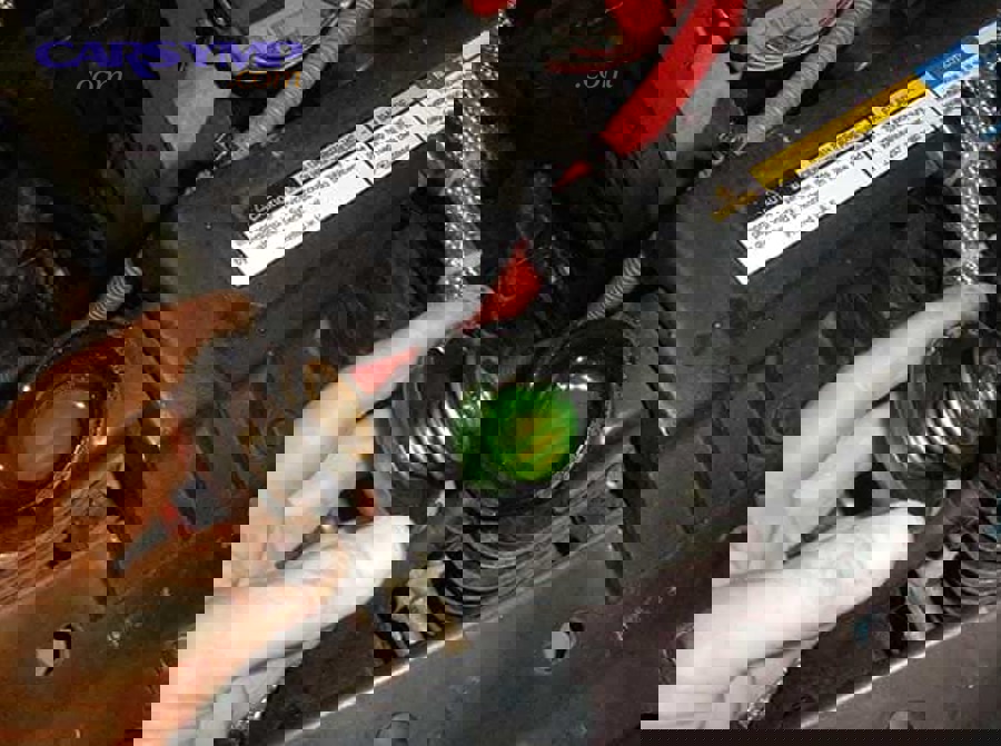 If coolant is low, what is the correct way to top it up without damaging the cooling system?