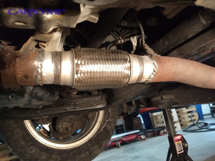 Braided exhaust flex pipe section installed under a vehicle