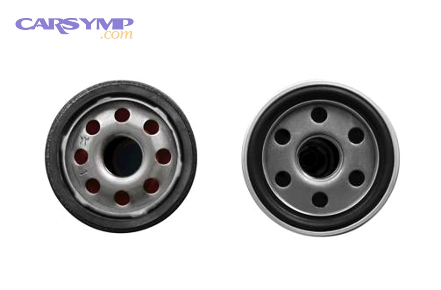 Hand holding a spin-on oil filter with packaging, illustrating discussion of cellulose vs synthetic filter media