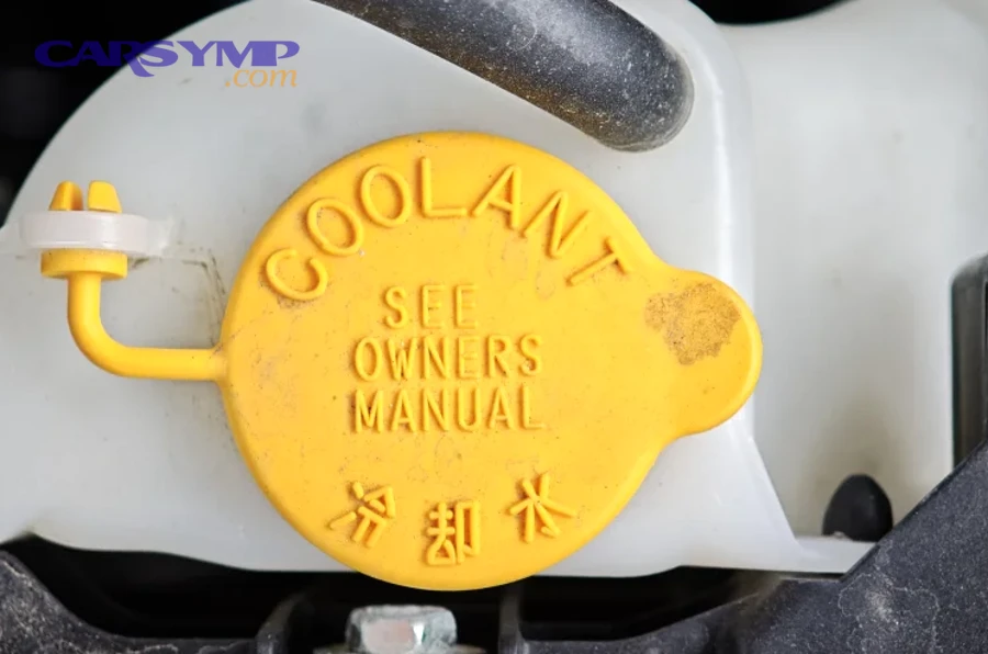 Coolant reservoir with MAX/MIN markings and orange coolant visible