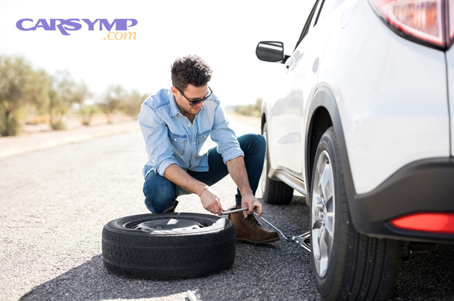 Car jack lifting a vehicle during tire change