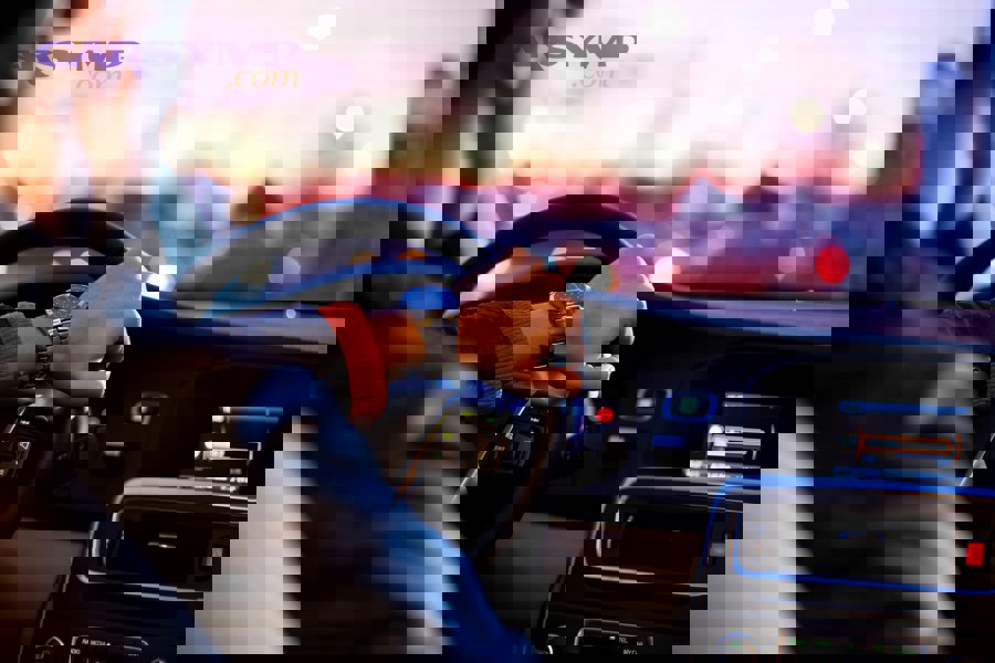 Modern car dashboard displaying digital instrument cluster and infotainment system with backup camera and blind spot monitoring features