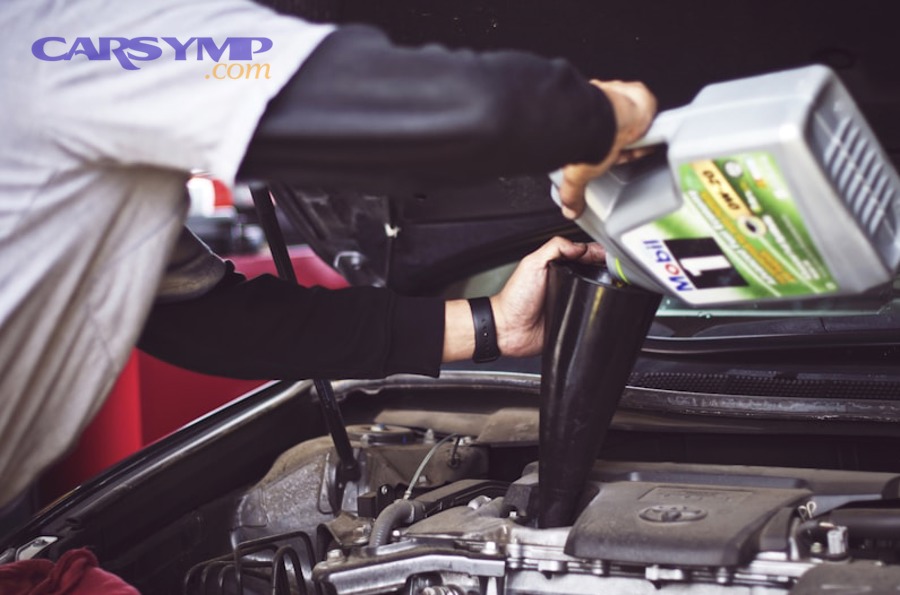 mechanic installing air intake hose with clamp