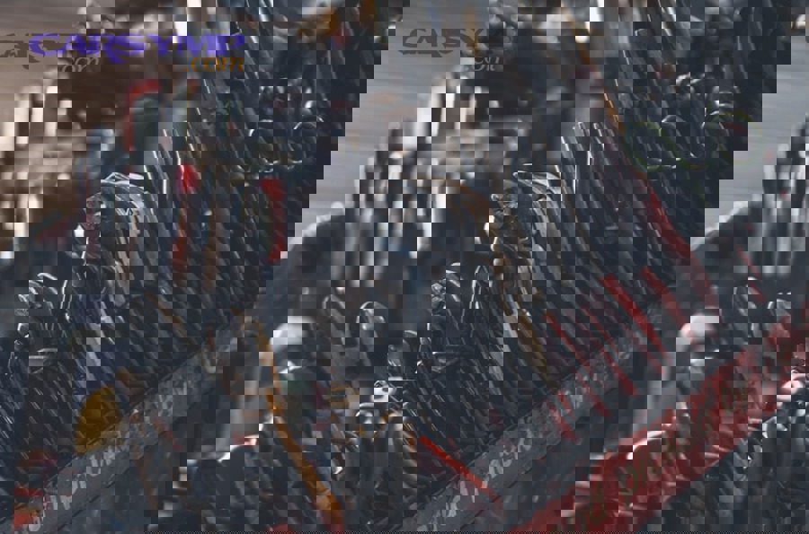 mechanic using calibrated torque wrench on engine bolt