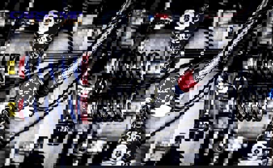 contaminated dark power steering fluid next to fresh clean fluid showing system deterioration