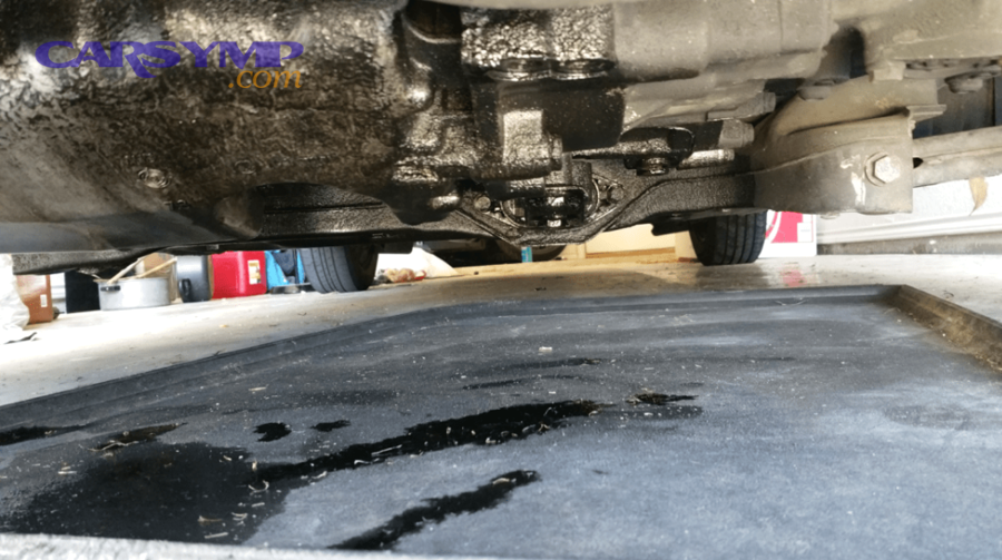 comparison of minor oil seepage versus major oil leak puddles under vehicle