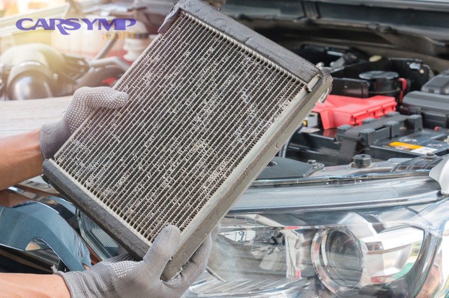 Technician working under a dashboard where heater core access time is concentrated
