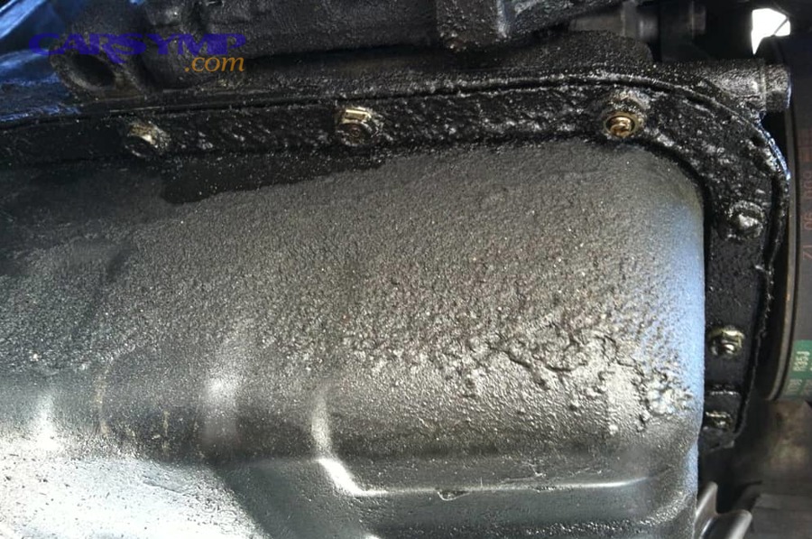 Car safely supported for underside inspection during leak diagnosis