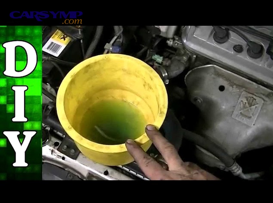 Automotive expansion tank showing normal coolant level markings and proper function in cooling system