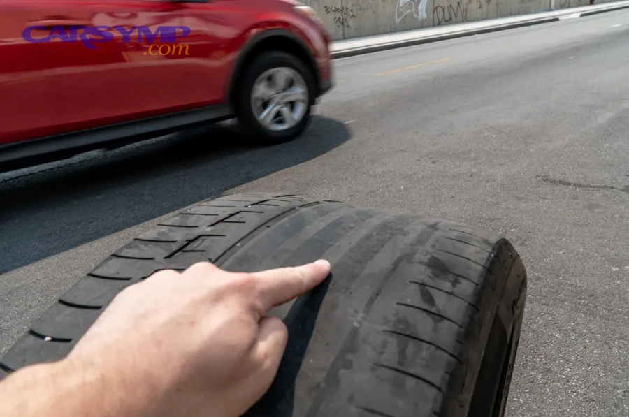 Driver checking tire pressure as part of regular maintenance