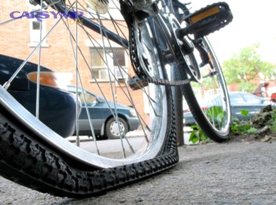 Flat tire on vehicle requiring puncture repair or replacement assessment