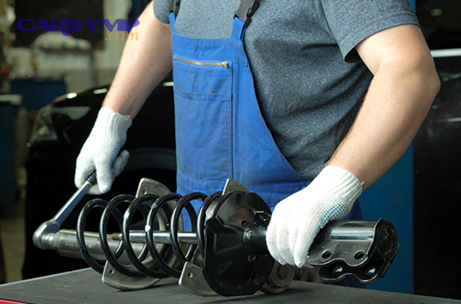 mechanic performing wheel alignment after suspension installation