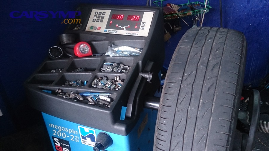 Wheel balancing machine showing how tire and wheel assemblies are corrected