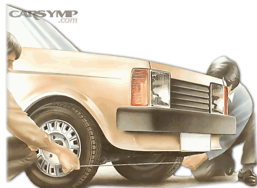 Technician checking alignment readings on a vehicle