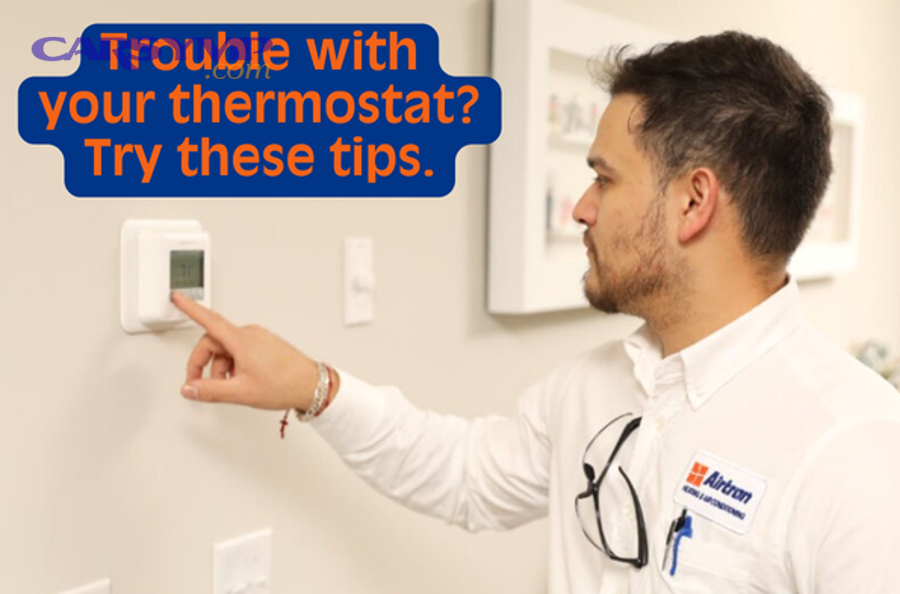 Hands installing fresh AA batteries into back of digital thermostat