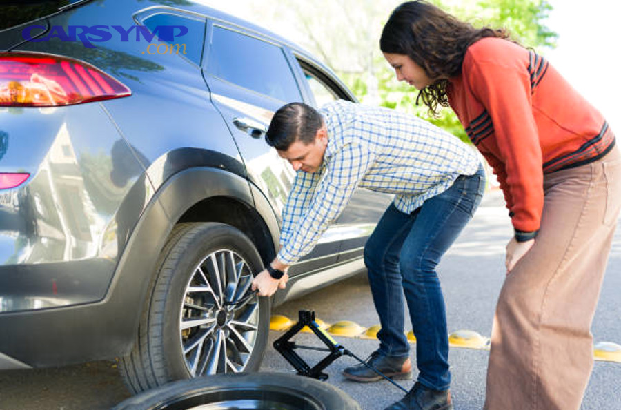 Mechanic inspecting wheel alignment and suspension components
