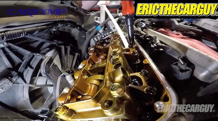 Car engine bay with valve cover area visible