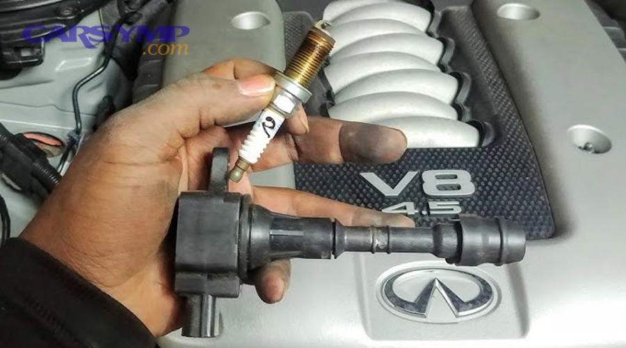 Engine valve cover area showing leak inspection around ignition components