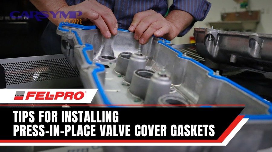 Engine bay showing the top of an engine where a valve cover gasket seals the valve cover