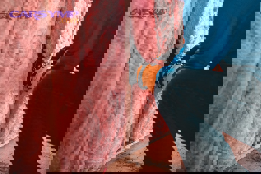 HVAC technician testing thermostat wiring with multimeter to diagnose power issues