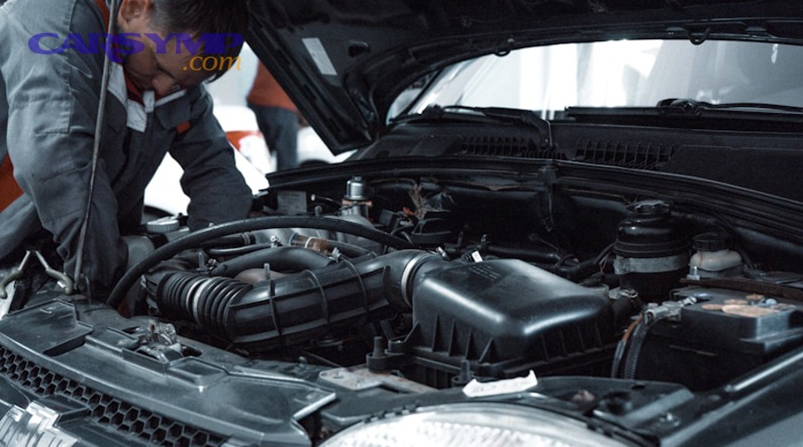 Car engine components showing spark plugs and ignition system